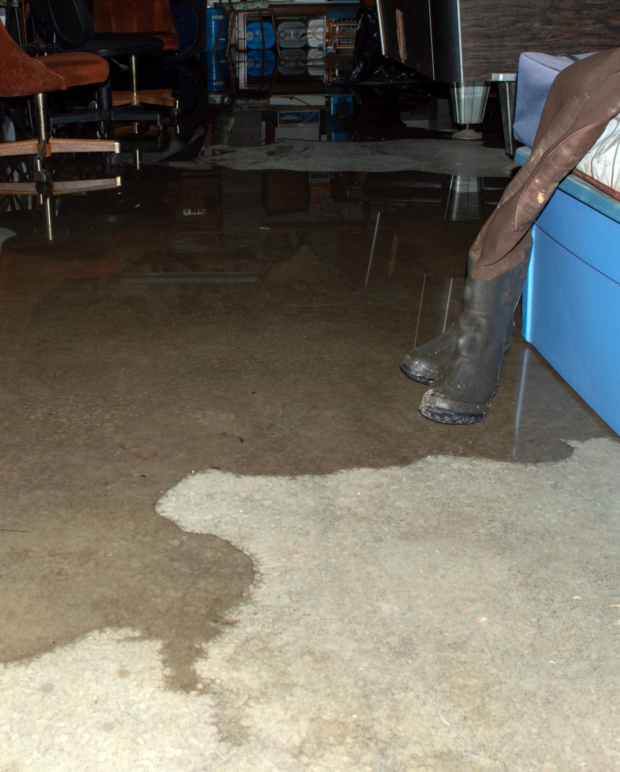 Water seeping across a concrete floor