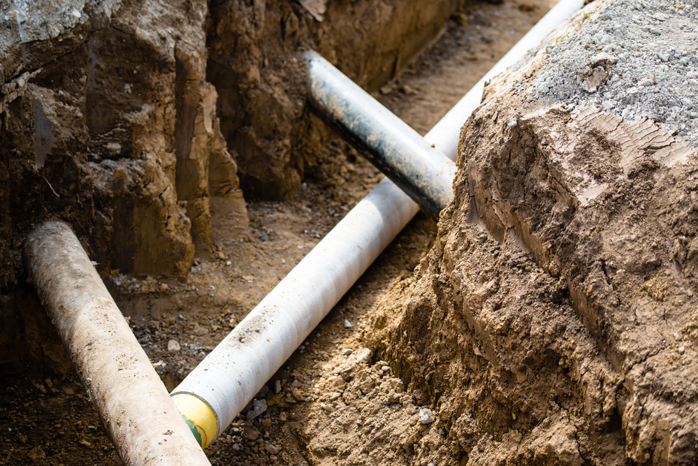 Exposed water supply line in an excavated trench